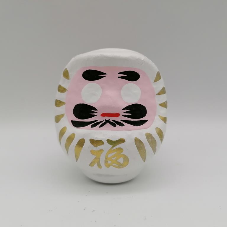 Bambola Daruma bianca tradizionale giapponese, vista frontale con dettagli del volto stilizzato